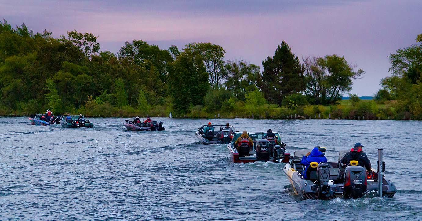 Boats heading out a sunrise.